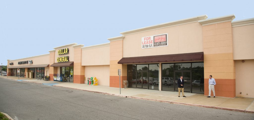 Retail center with "For Lease" sign, Dollar General, and other commercial tenants