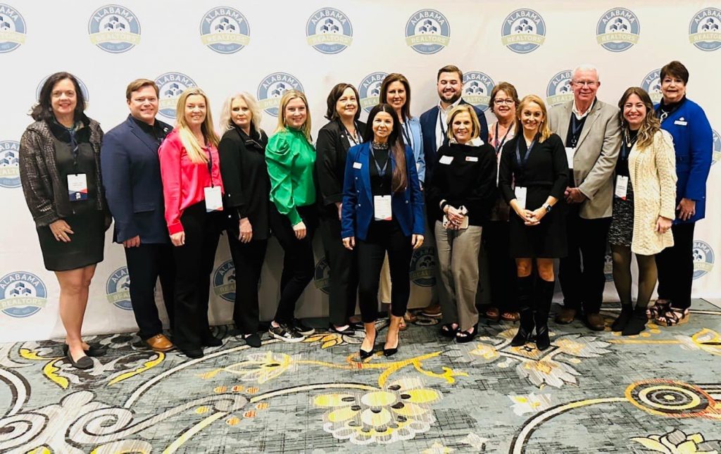 Group of real estate agents gathered at the Alabama REALTOR Day 2023 in Montgomery, AL. White-Spunner Realty's Tracy Womack is in the pink shirt. 