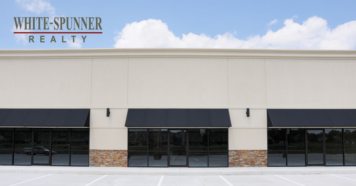 White-Spunner Realty commercial office building with black awnings and stone accents